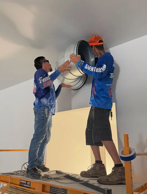 Airenteed HVAC technician servicing an air conditioning system