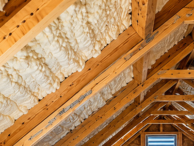 Completed spray foam insulation along sloped attic roof decking