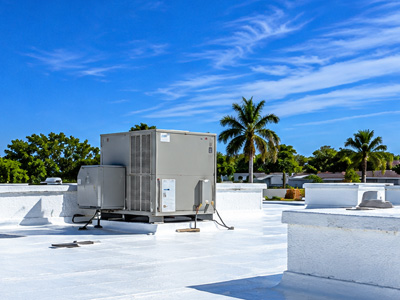 Commercial rooftop with HVAC equipment and white roof insulation coating